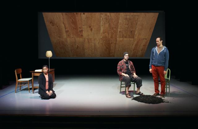 Three actors sit onstage.