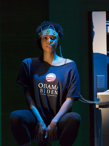 Actor on stage in an Obama biden shirt and wearing a crown