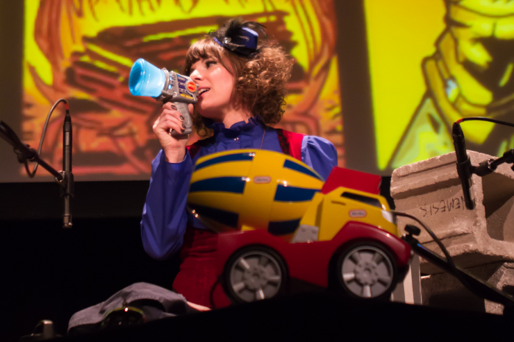 Actor on stage with a toy truck