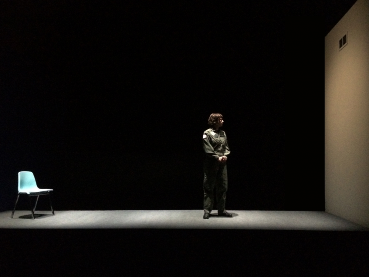 an actress alone on a blank stage