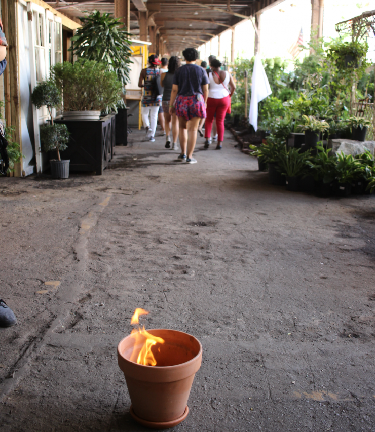 a group of people walking away from a burning plant
