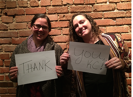 two women posing with thank you cards