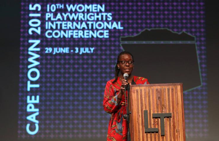 a woman giving a speech at a podium