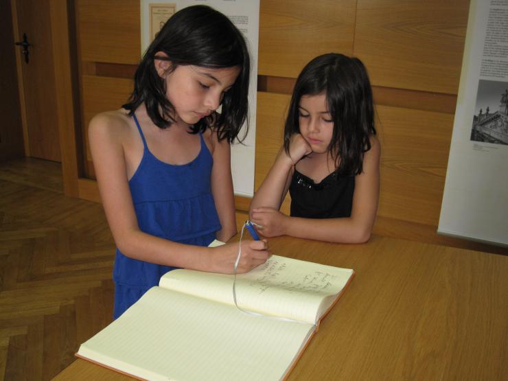 two young girls writing