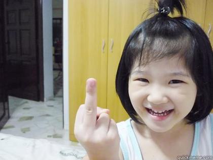 young child raising middle finger to the camera