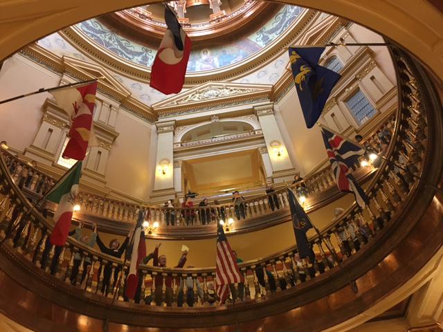 State house rotunda with people chanting