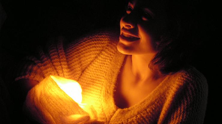an actress holding a light