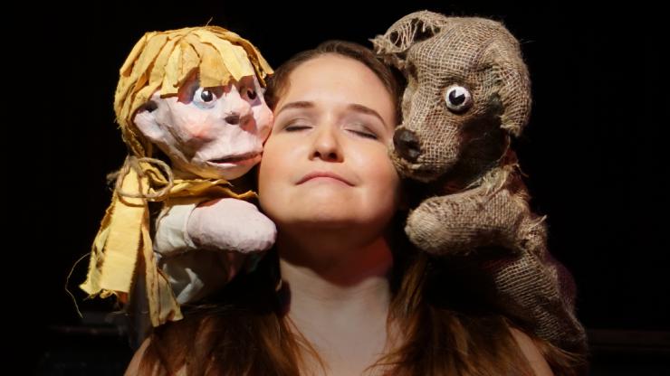 a woman posing with puppets