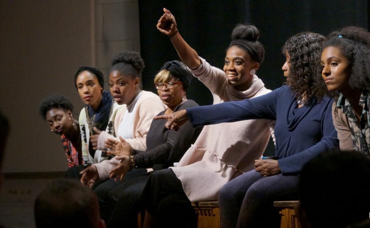 seven black women sitting onstage