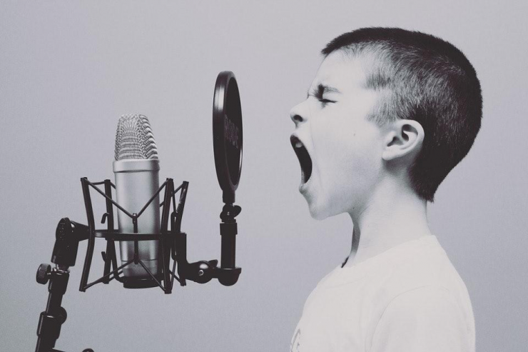 a child yelling into a mic