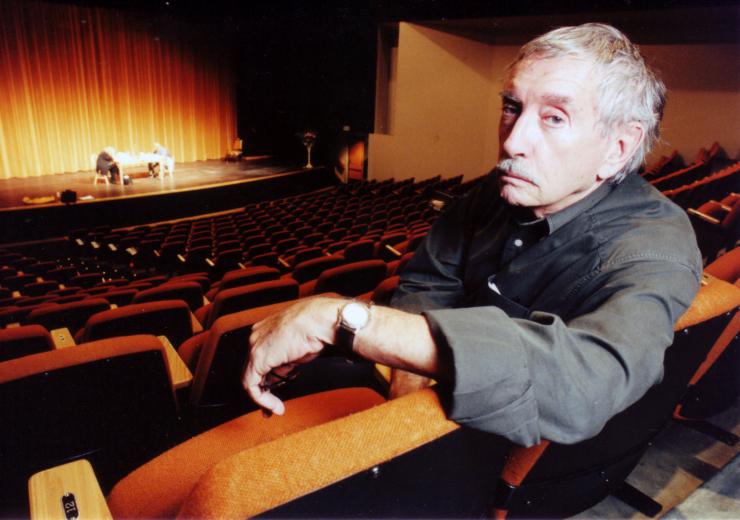 director/teacher sitting in a theater