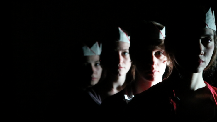 a group of actors wearing crowns