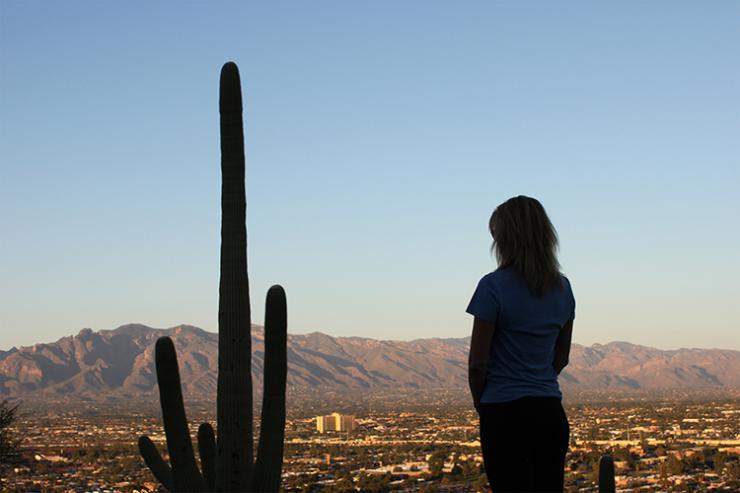 woman facing a cactus