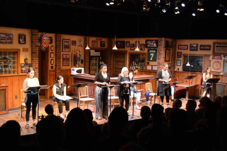 a group of actors in a staged reading