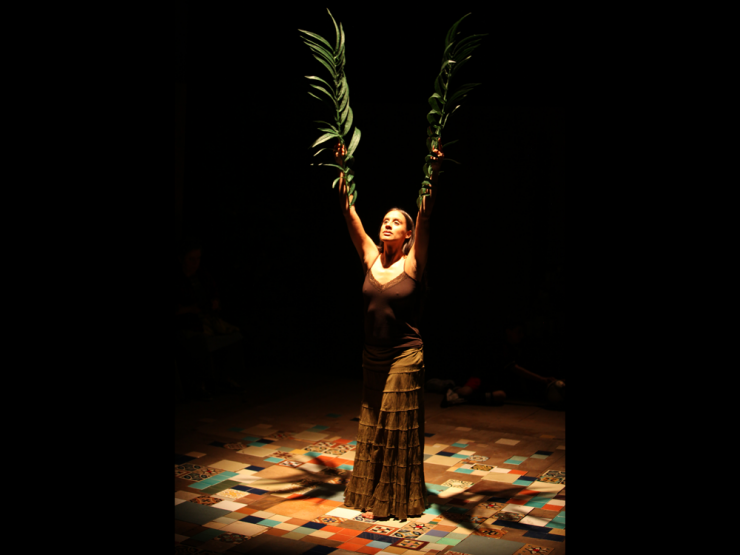 an actress performing with leaves