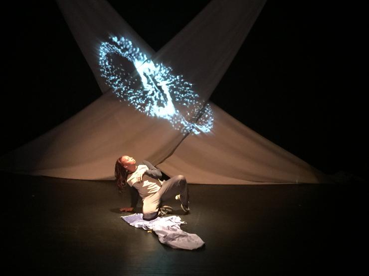 an actress performing in front of a projection