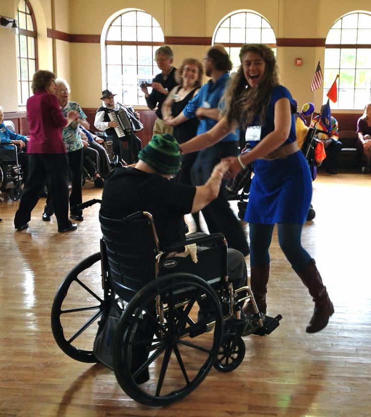 a woman dancing with someone in a wheelchair