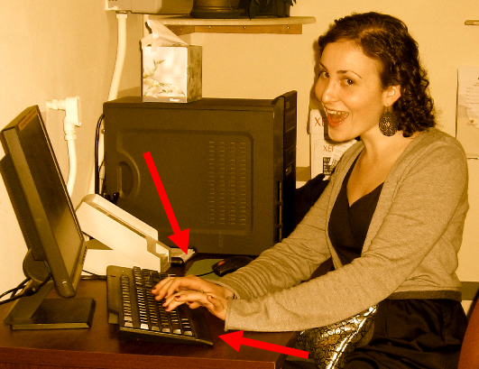 a woman smiling at her computer
