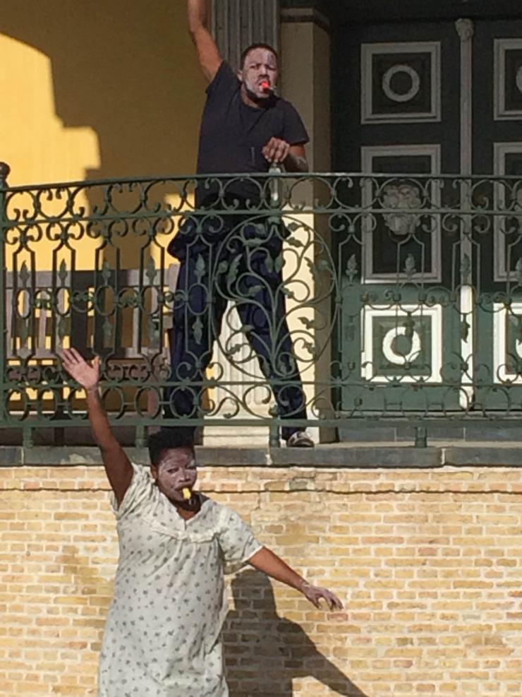 two actors dancing on a balcony