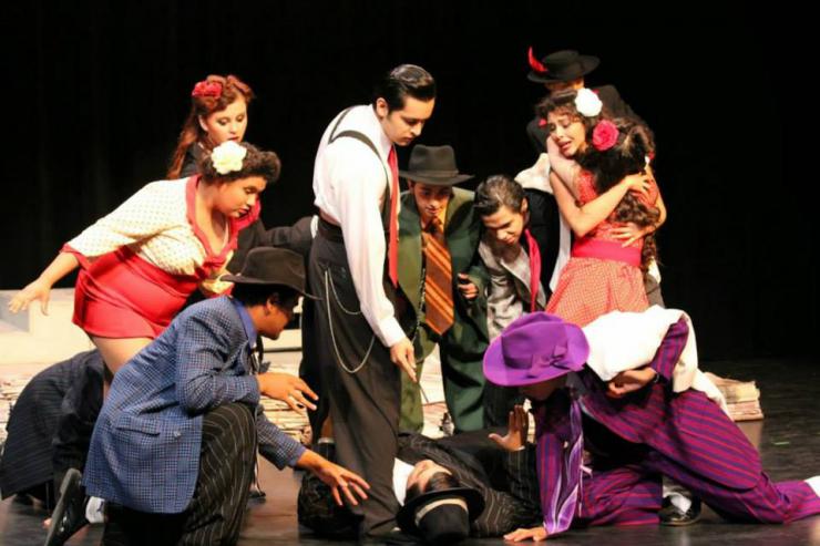 a group of young actors on stage in period costumes
