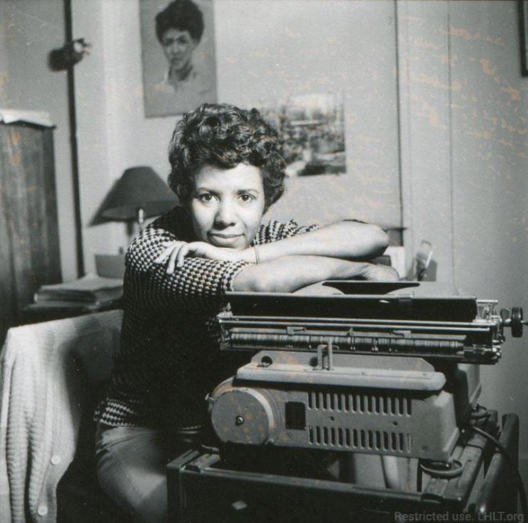 a woman sitting by her type writer 