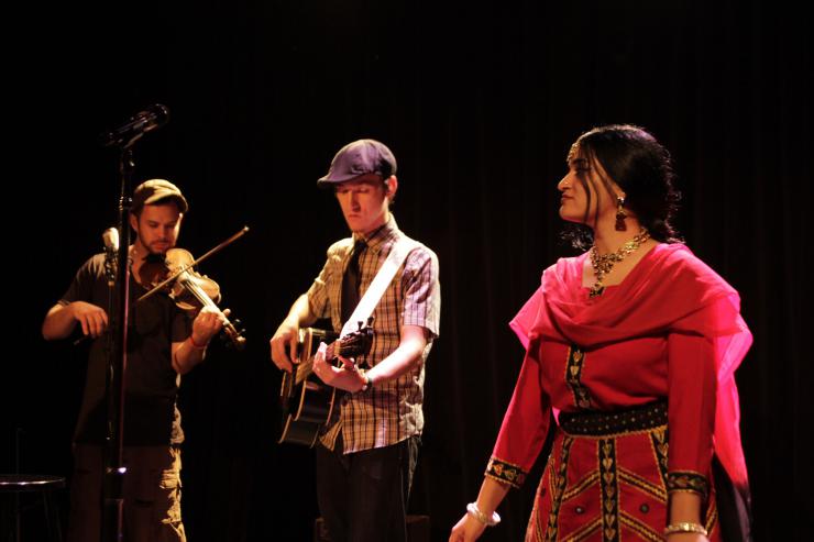 an actress with musicians on stage