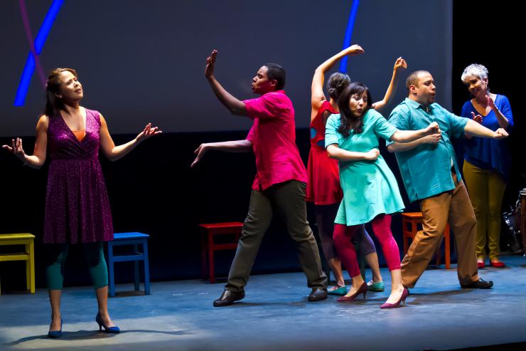 a group of people dancing on stage