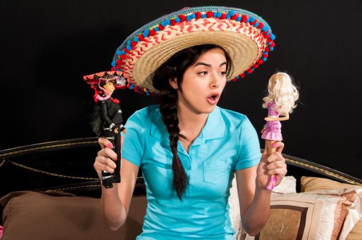 an actress in a sombrero playing with dolls