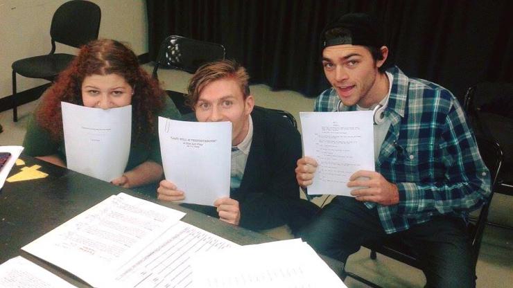 three writers posing with scripts