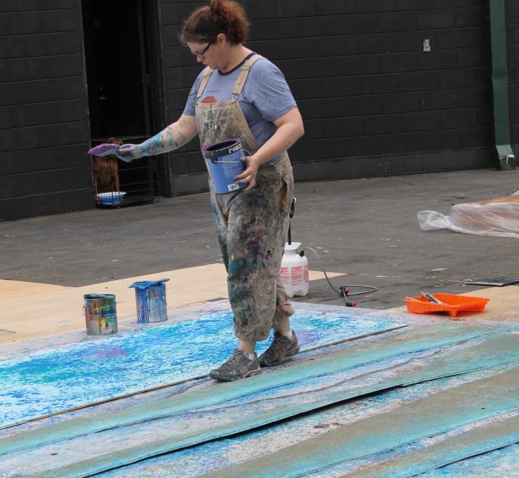 a woman painting a set