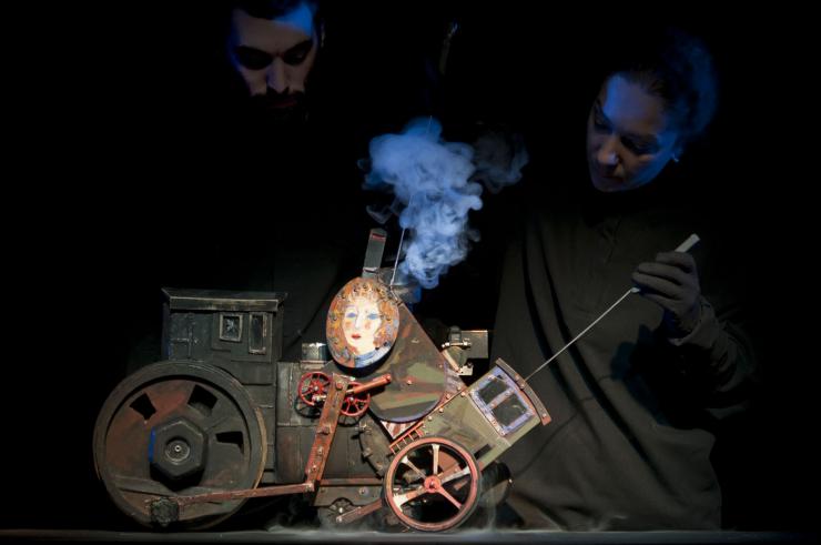 two puppeteers operating a puppet