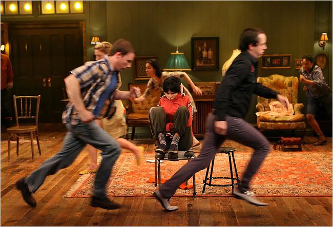 Young actor in chair while others run around them