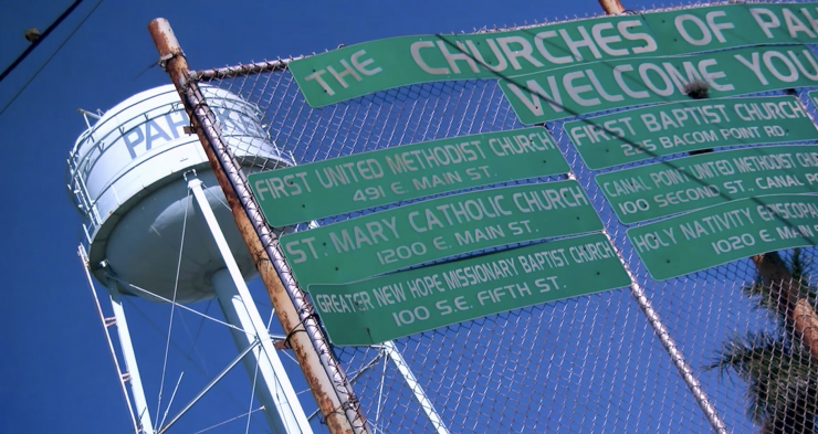 signs for churches on a fence