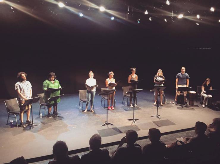 eight performers in a staged reading