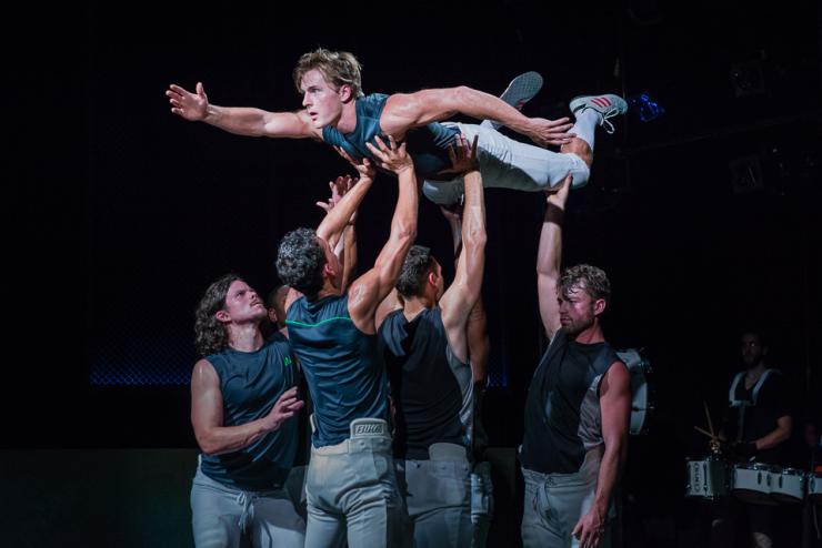 men holding another man in the air 