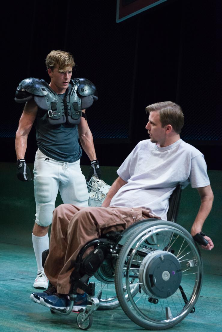 two actors onstage, one in a wheelchair