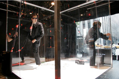 People climbing in a glass box