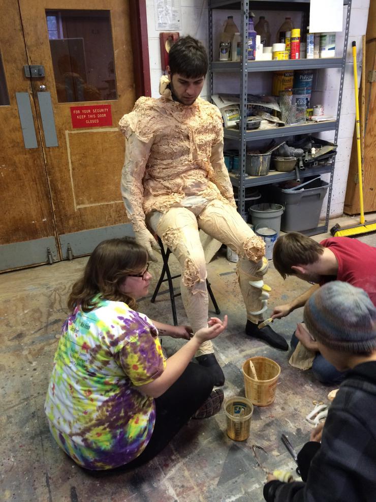 Students working on a cast costume 
