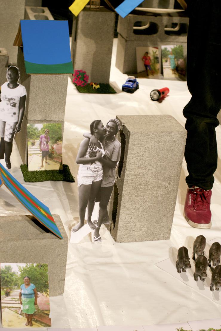 cinderblocks and cut out photos placed onstage to make a theatrical set
