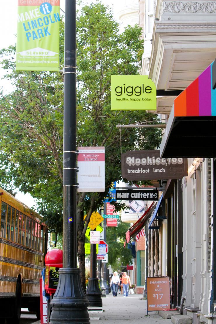 a sidewalk lined with stores 