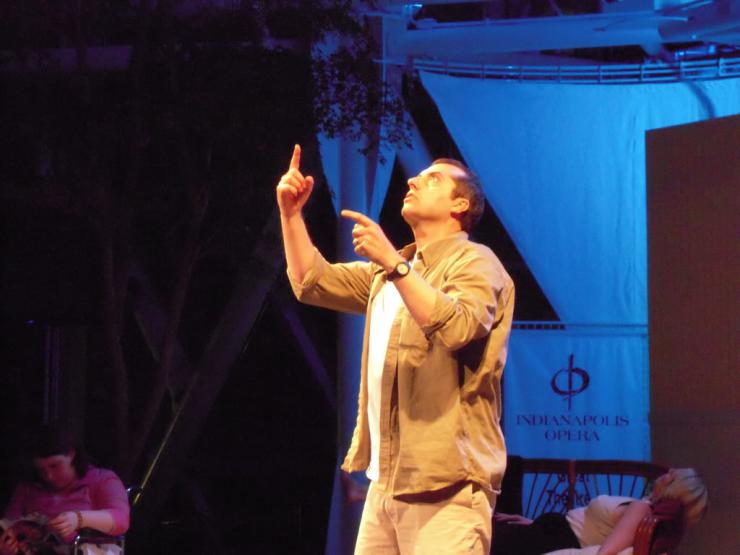 a performer on stage pointing 