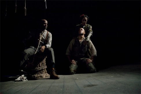 three performers sitting onstage