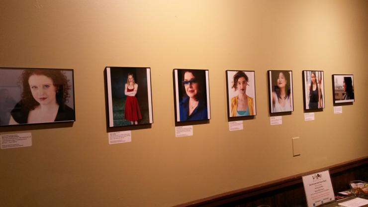Wall with framed photographs of women playwrights