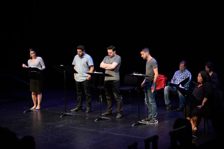 Actors on stage for a reading