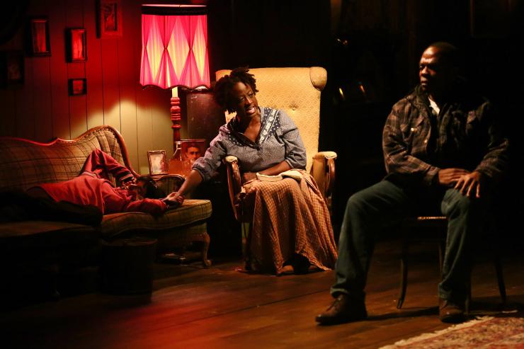 Three actors in a living room set