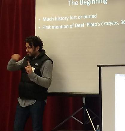 man giving a speech using sign language
