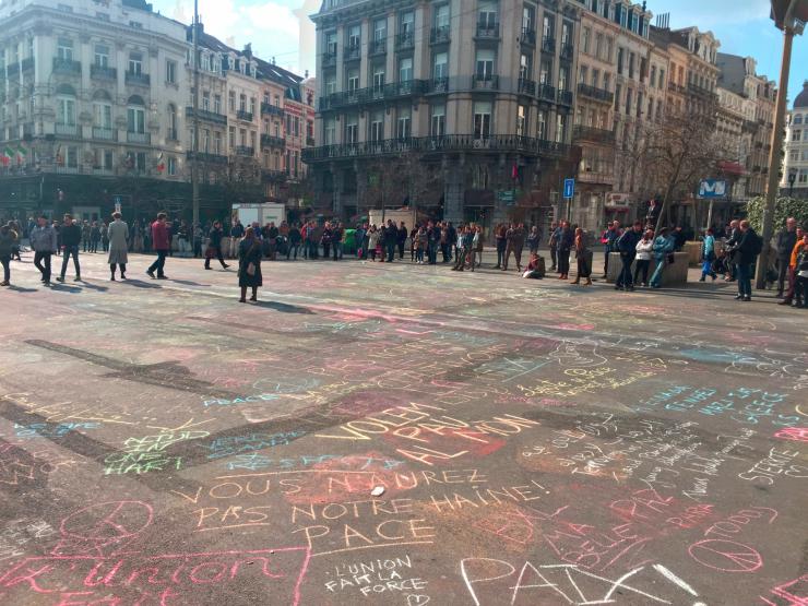 a square in Brussels full of political messages written in chalk