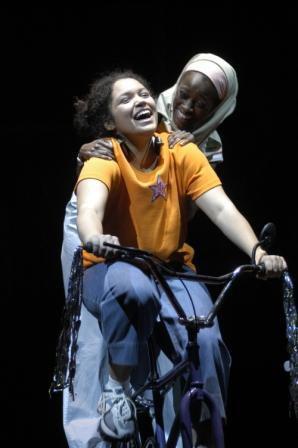 Two women on a bicycle on stage 