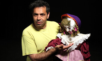 A performer holding a puppet.