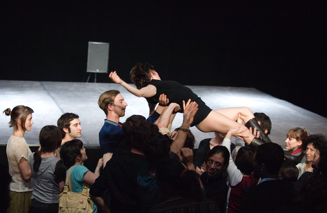 performer being held up by audience members